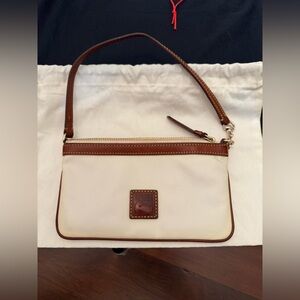 Dooney and Bourke white cotton canvas and vachetta leather trim wristlet.